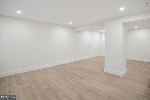 basement with light hardwood / wood-style floors