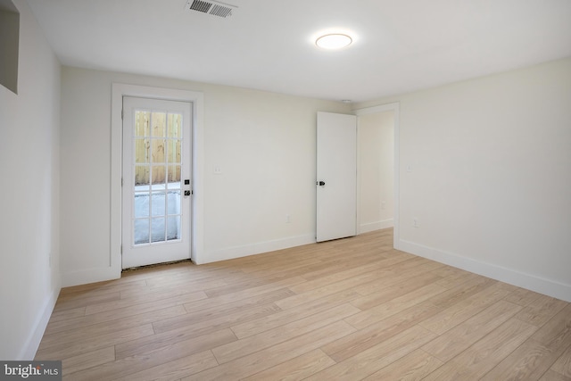 spare room with light hardwood / wood-style flooring