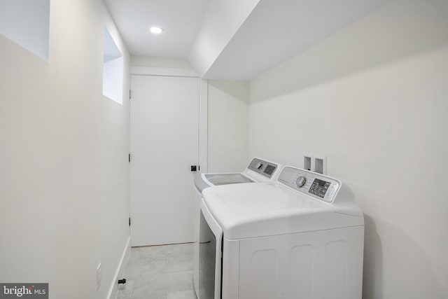 clothes washing area featuring separate washer and dryer