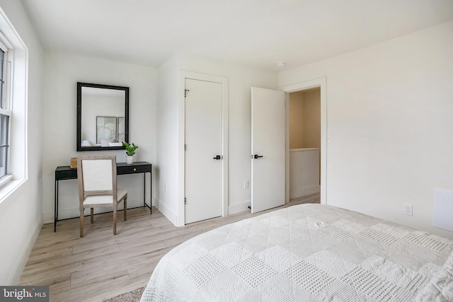 bedroom with baseboards and wood finished floors