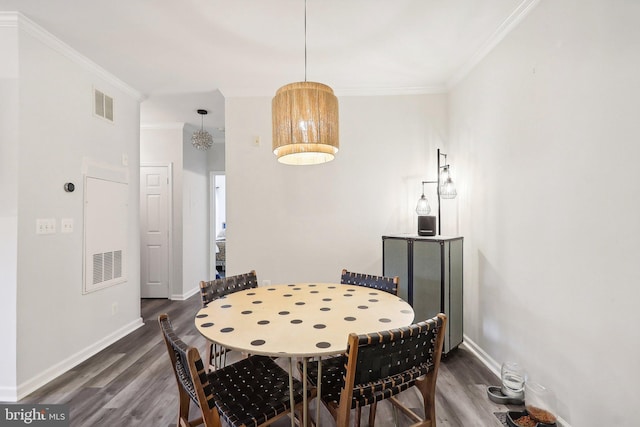 dining room featuring crown molding and dark hardwood / wood-style floors