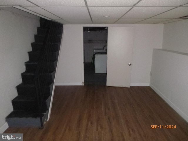 finished basement with stairs, a drop ceiling, baseboards, and wood finished floors