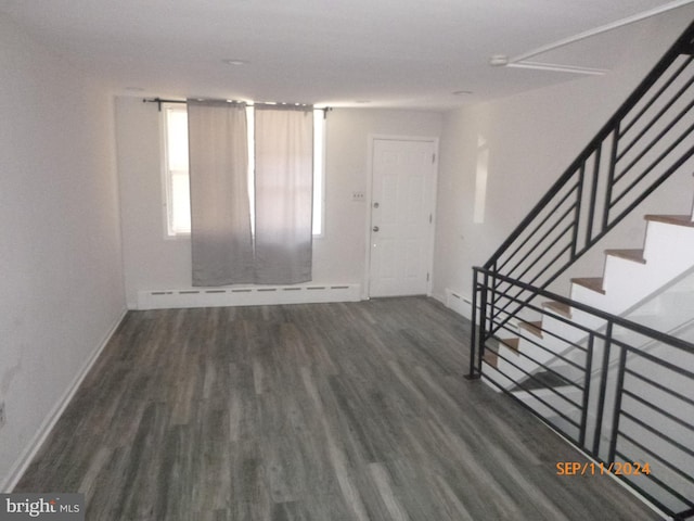 foyer entrance featuring baseboard heating and dark hardwood / wood-style flooring