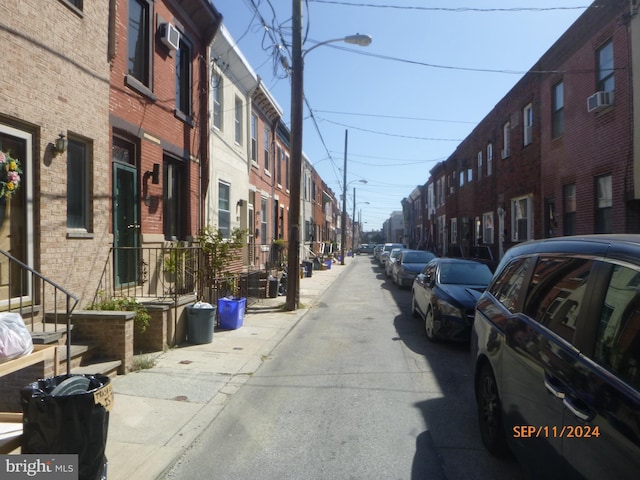 view of street with street lights, sidewalks, and a residential view