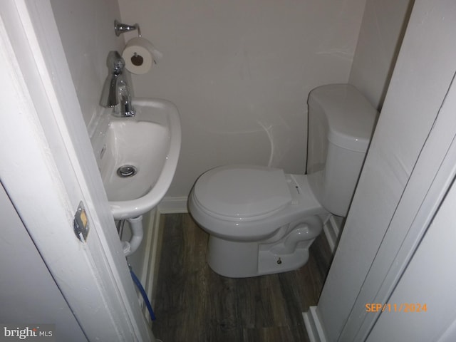 bathroom featuring toilet and wood finished floors