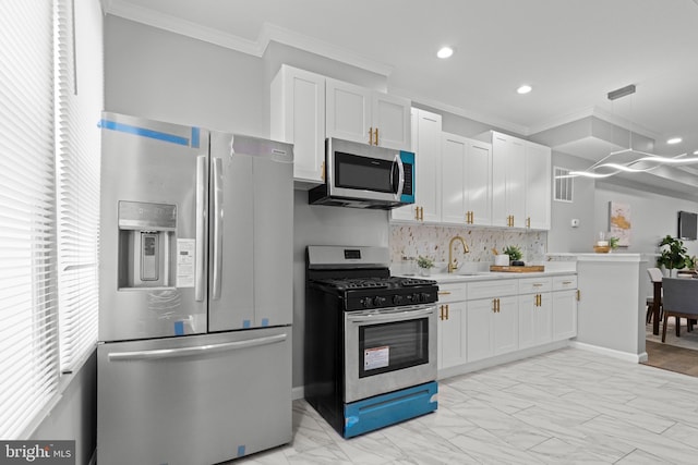 kitchen featuring white cabinets, sink, ornamental molding, backsplash, and stainless steel appliances