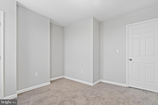 spare room with light colored carpet