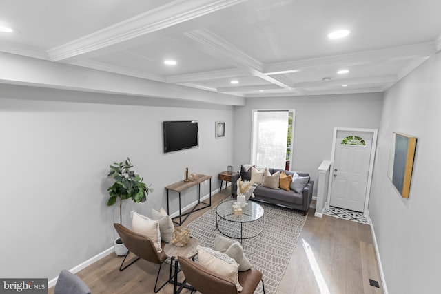 living room with coffered ceiling, beamed ceiling, hardwood / wood-style flooring, and ornamental molding