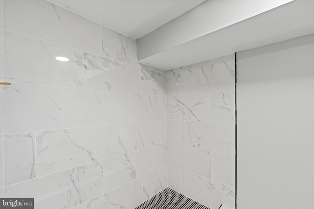 bathroom with tiled shower