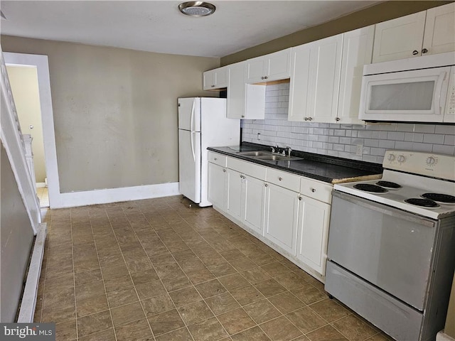 kitchen with white cabinets, backsplash, white appliances, a baseboard radiator, and sink