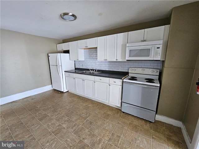 kitchen featuring decorative backsplash, white appliances, sink, and white cabinets