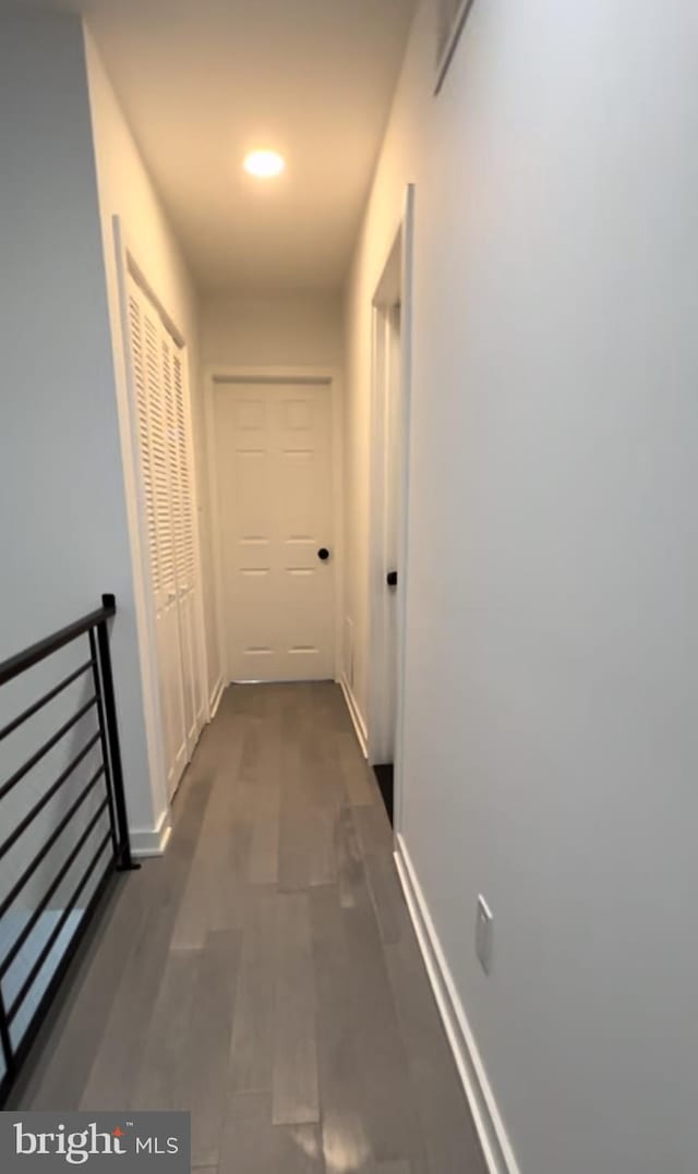 hallway with dark wood-type flooring