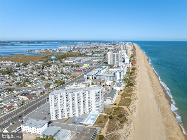 birds eye view of property with a water view and a view of the beach