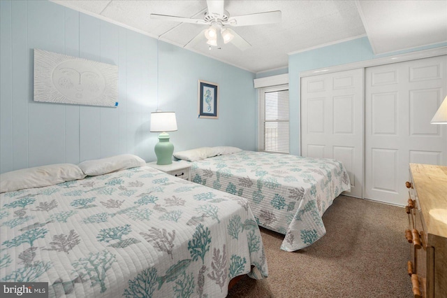 carpeted bedroom with a closet, ceiling fan, and a textured ceiling