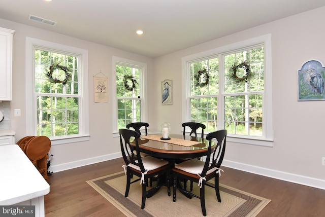 dining space with dark hardwood / wood-style flooring