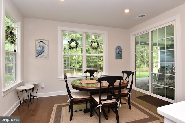 dining space with dark hardwood / wood-style floors