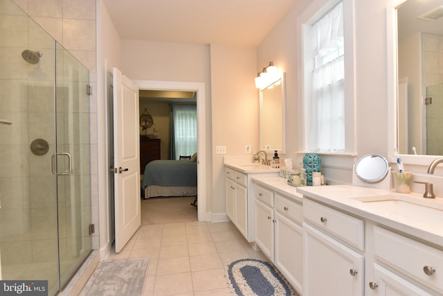 bathroom with tile patterned flooring, a shower with shower door, and vanity