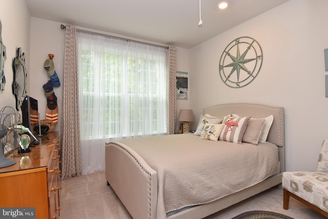 bedroom featuring light carpet