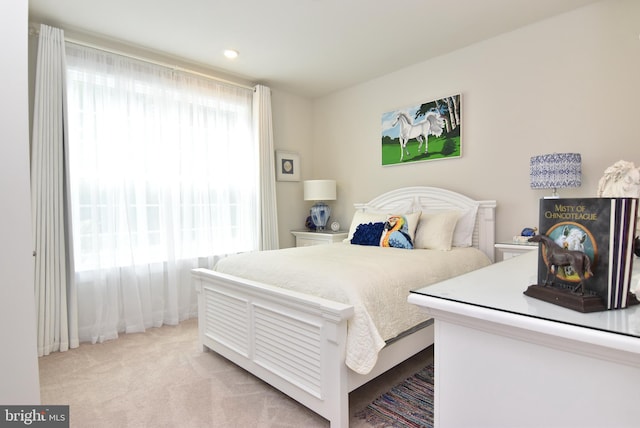 bedroom featuring light carpet