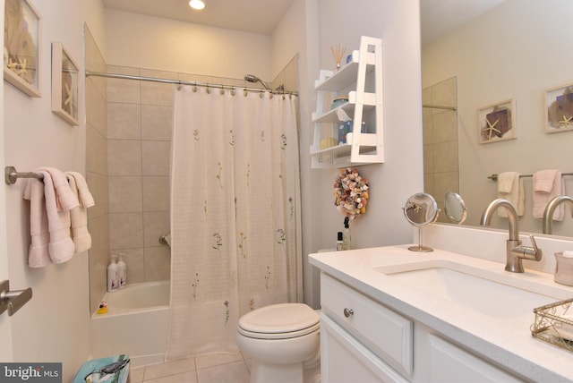 full bathroom featuring shower / bath combo with shower curtain, tile patterned floors, vanity, and toilet