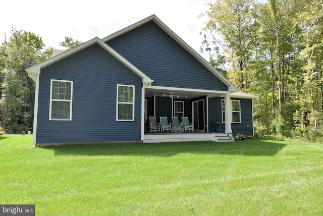 rear view of house featuring a lawn