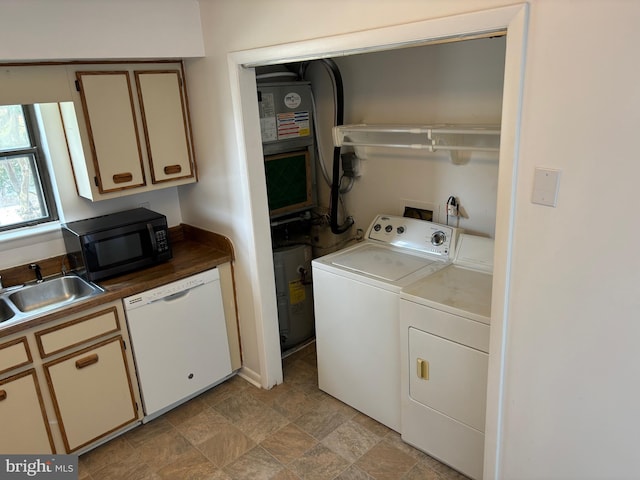 laundry area featuring washing machine and dryer and sink