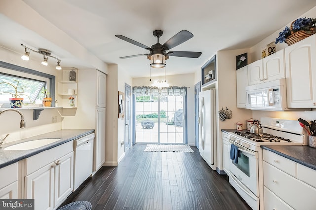 kitchen with white cabinets, white appliances, ceiling fan, dark hardwood / wood-style floors, and sink