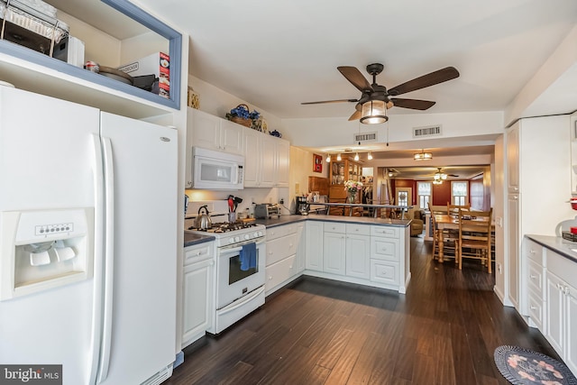 kitchen with white cabinets, kitchen peninsula, white appliances, dark hardwood / wood-style flooring, and ceiling fan