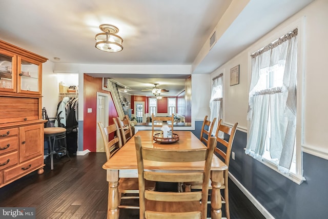 dining room with dark wood-type flooring and ceiling fan