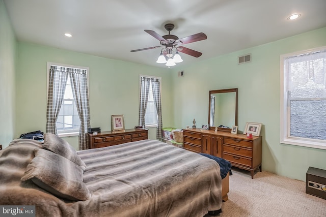 bedroom with ceiling fan and light colored carpet