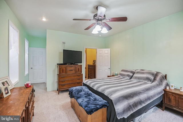 bedroom with ceiling fan and light carpet