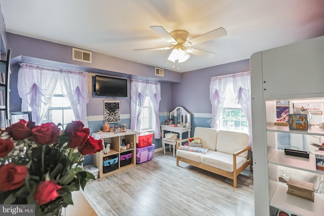 sitting room featuring a wealth of natural light, light hardwood / wood-style floors, and ceiling fan