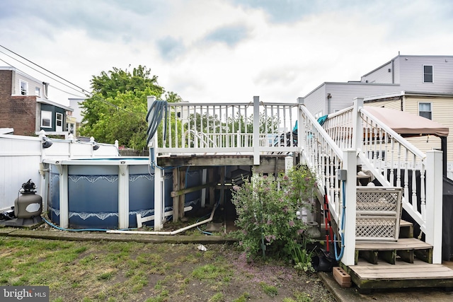 back of property featuring a pool side deck