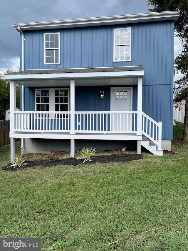 view of front facade with covered porch and a front yard