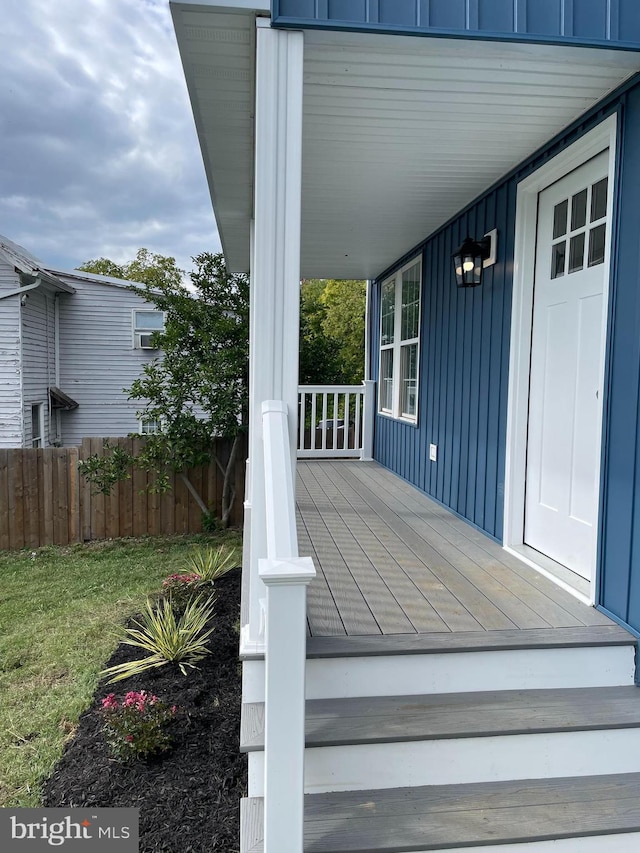 deck with a yard and a porch