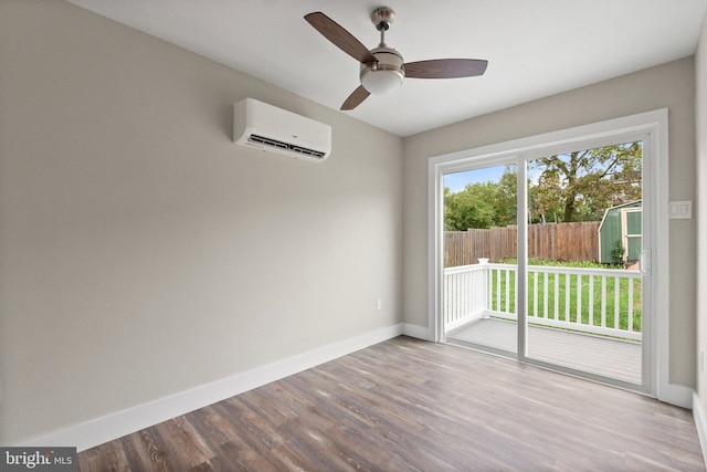 unfurnished room with wood-type flooring, ceiling fan, and a wall unit AC