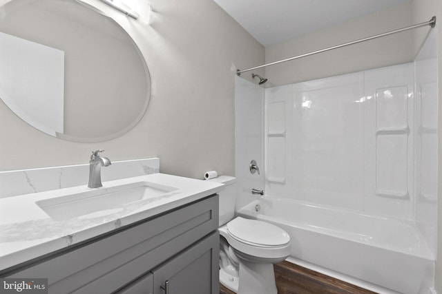 full bathroom with shower / tub combination, vanity, toilet, and hardwood / wood-style flooring