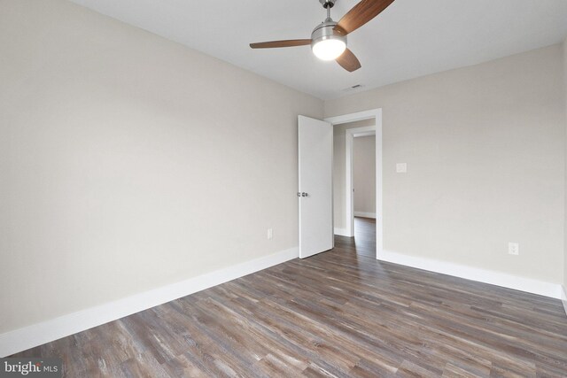 unfurnished room with ceiling fan and dark hardwood / wood-style floors