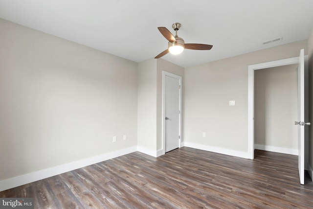 unfurnished bedroom with dark hardwood / wood-style flooring and ceiling fan