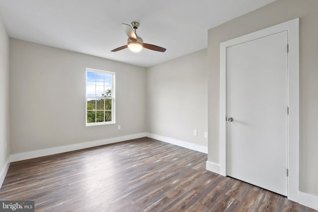 empty room featuring ceiling fan and dark wood-type flooring