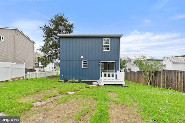 rear view of property with a lawn