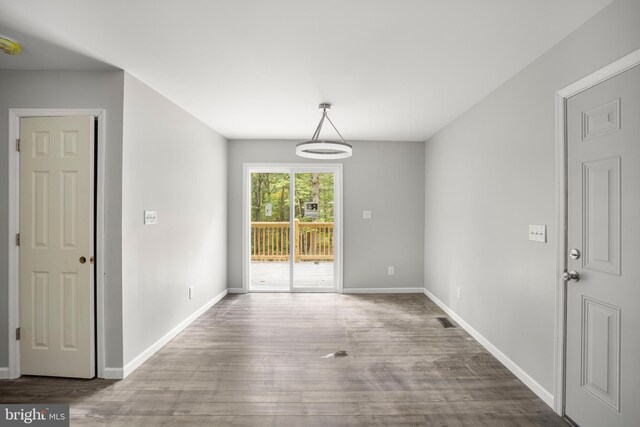 spare room with hardwood / wood-style floors