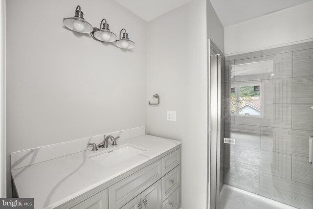 bathroom with walk in shower and vanity