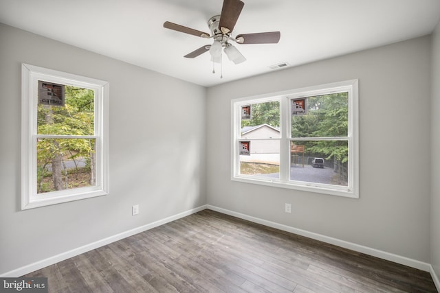 unfurnished room featuring ceiling fan, plenty of natural light, and hardwood / wood-style floors