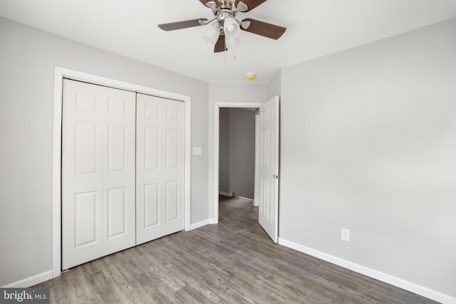 unfurnished bedroom with ceiling fan, a closet, and wood-type flooring