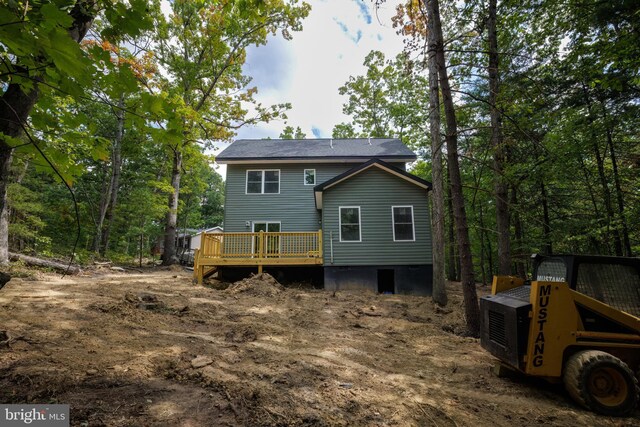 rear view of house featuring a wooden deck