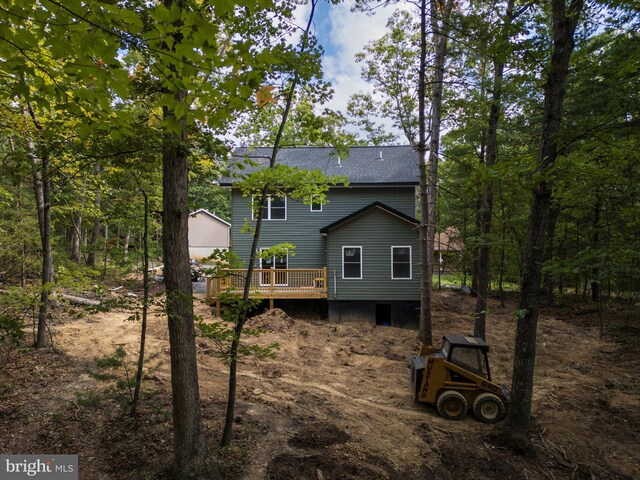 back of house with a deck