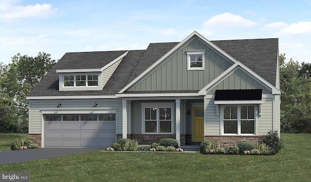 view of front of house featuring a front lawn, covered porch, and a garage