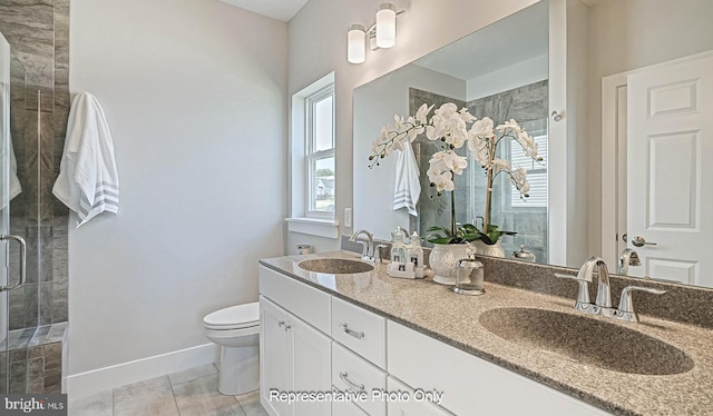 bathroom featuring tile patterned flooring, vanity, toilet, and an enclosed shower