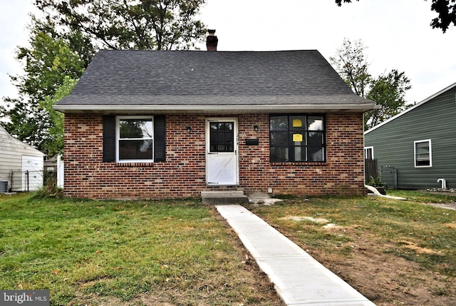 bungalow-style home featuring a front yard